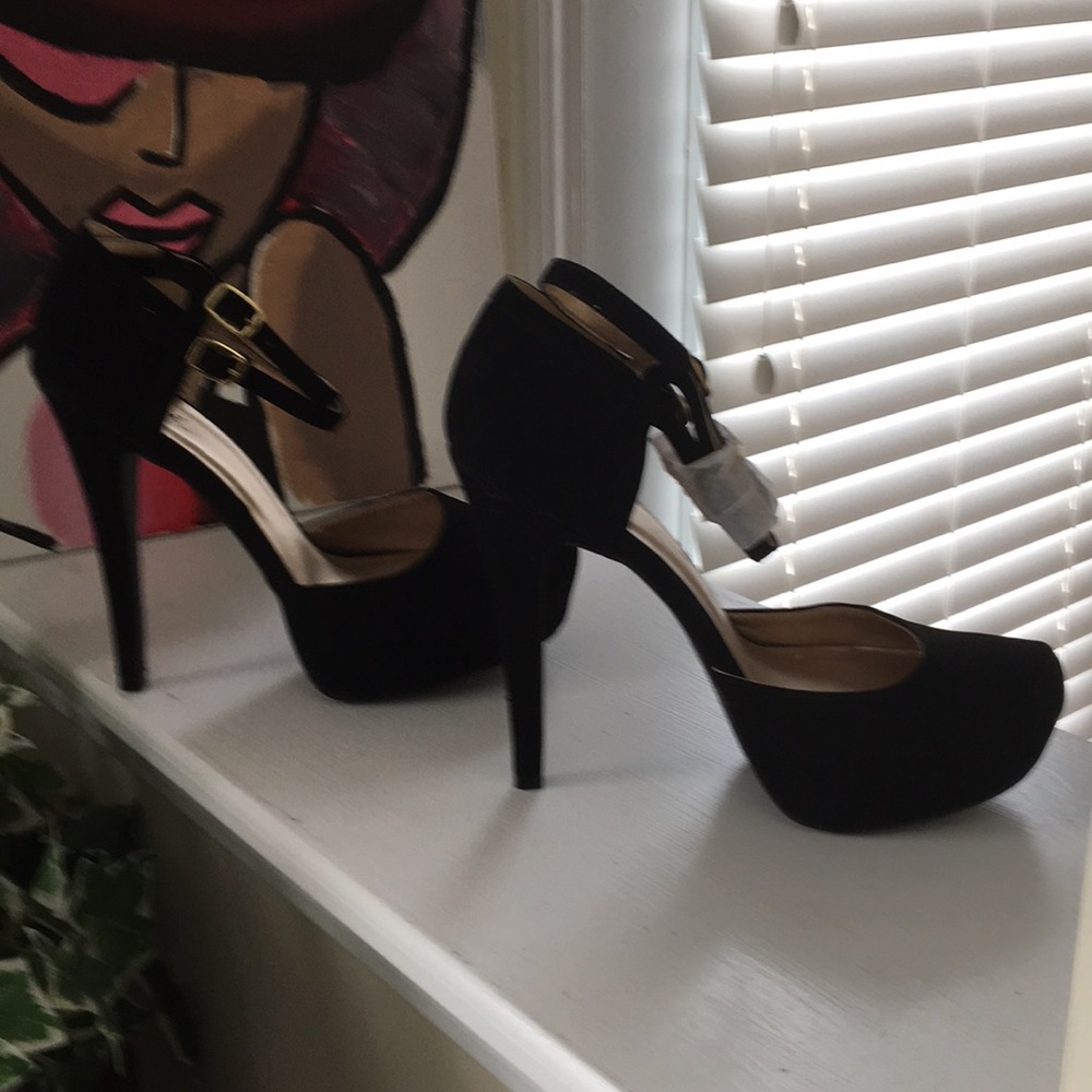Black suede heels never worn. Scuff marks